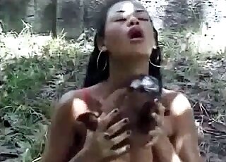 Ebony seduces dog for sex in the forest during XXX bestiality video