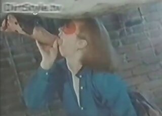 Redheaded lady dressed in blue blows a hung horse with passion