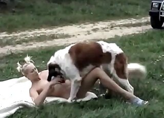 Skinny blonde seduces her fluffy dog to fuck her outdoors