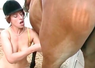 Horny cowgirl gets naked and goes for a huge cock of her stallion