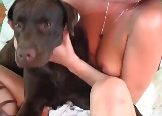 Kinky mature takes her dog in bed and gives the beastl her pussy